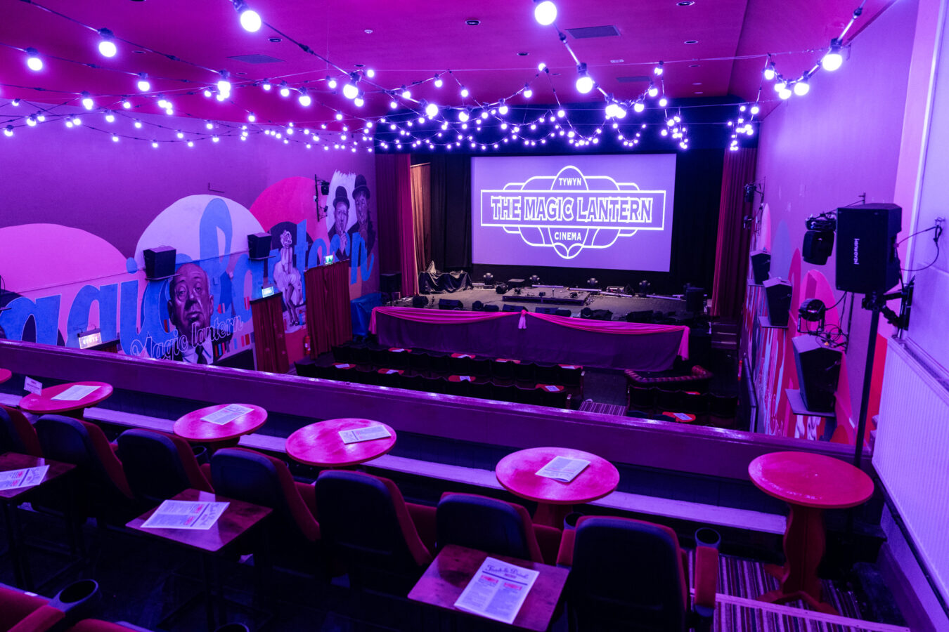 Main hall inside the Magic Lantern Cinema with purple ambient lighting.