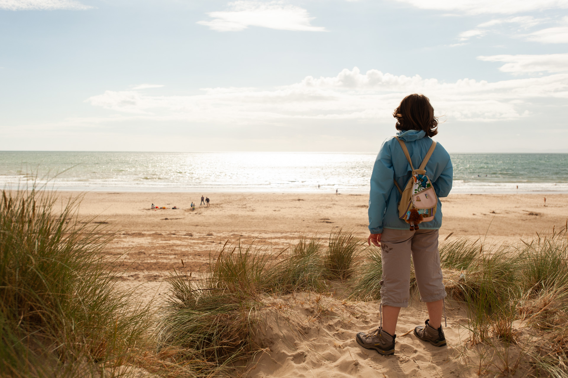 Woman overlooking a large sandy beach