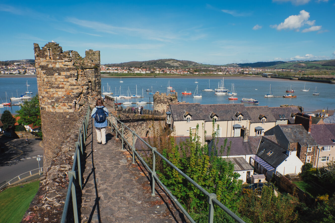 Walking on the town wall with harbour and river Conwy in the background