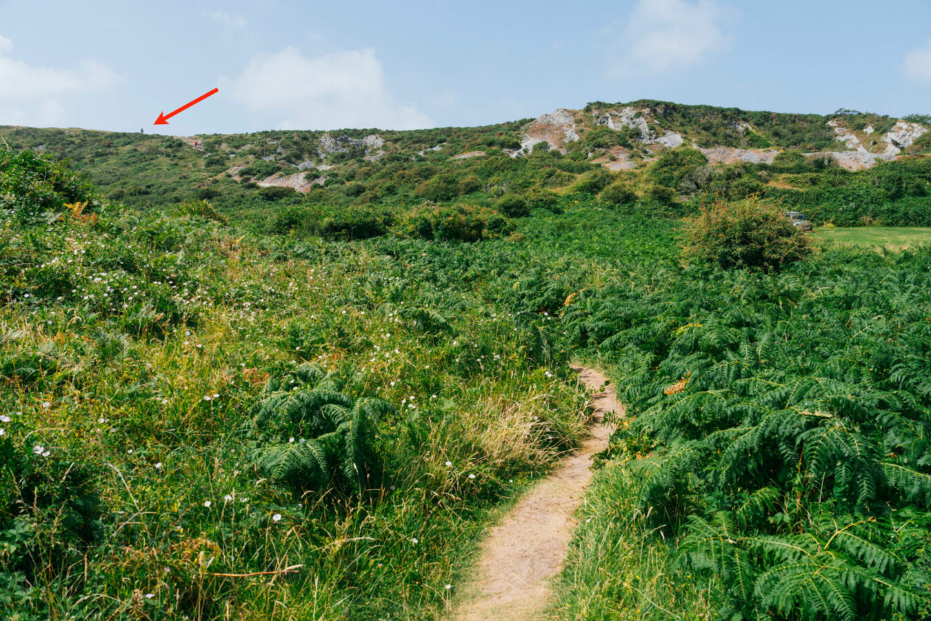 Path and cliff in the background with arrow showing memorial at the top