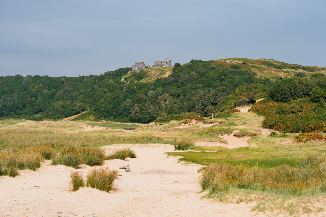 Pennard Castle up on the hill in the distance