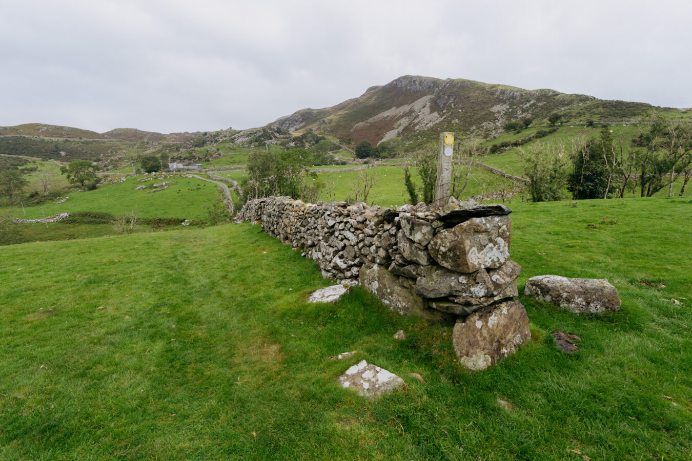 Descending along a stone wall on the right