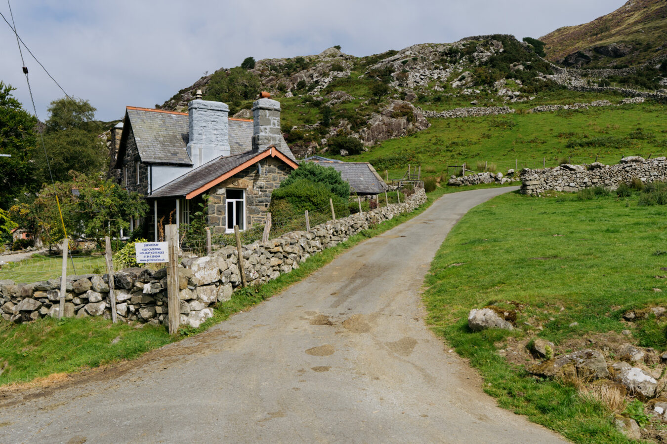 Paved road next to a cottage