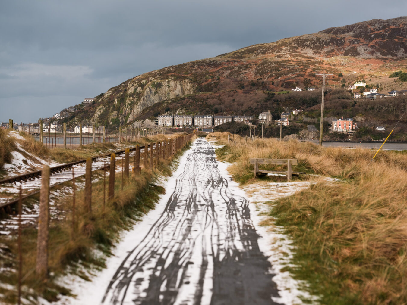 Path leading to Barmouth bridge covered in snow