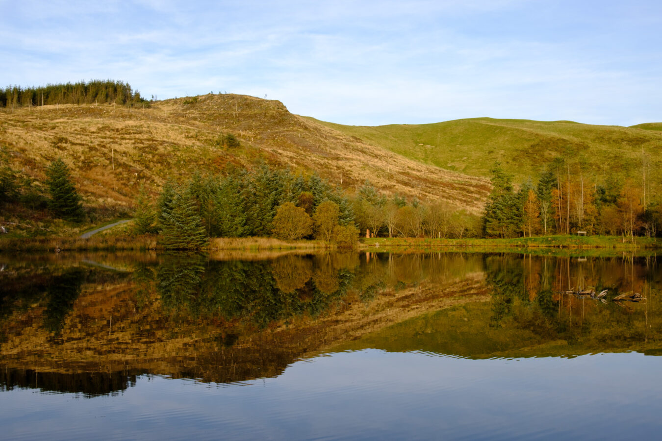 Hills with reflection on the lake in Bwlch Nant yr Arian