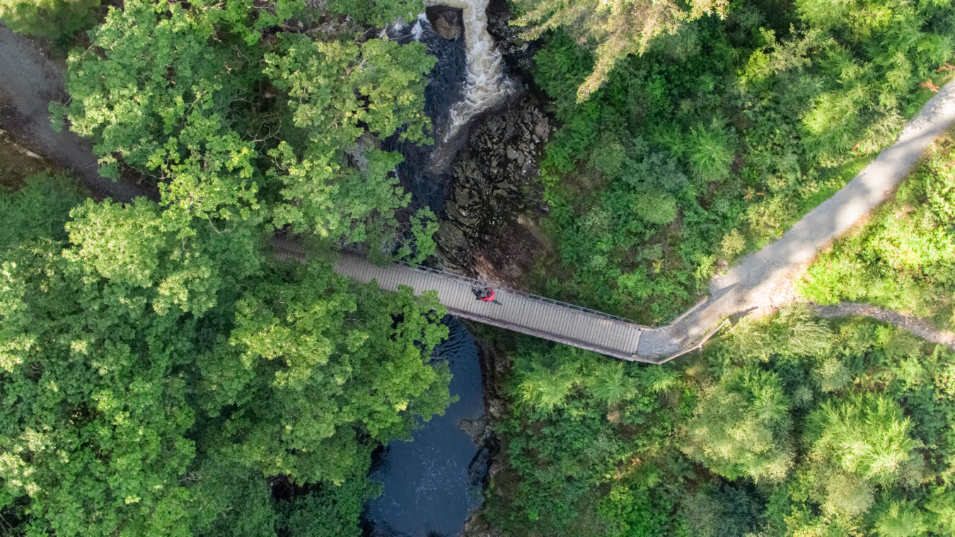 Aerial view of bike crossing a bridge in Coed y Brenin