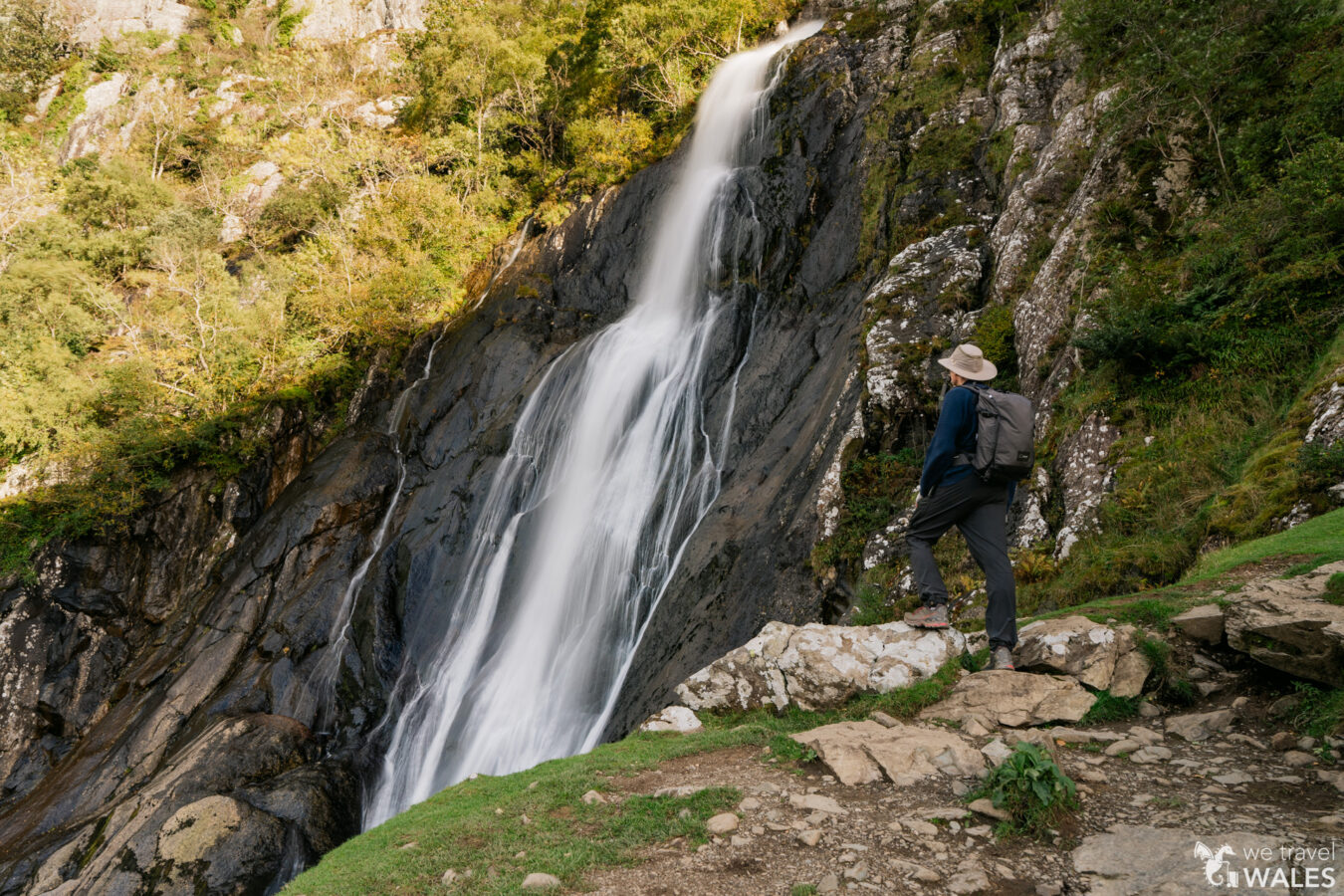 Male standing next to the upper viewpoint of the waterfall at Aber Falls