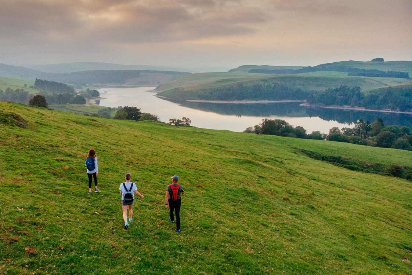 Hikers on the hill with lake in the background