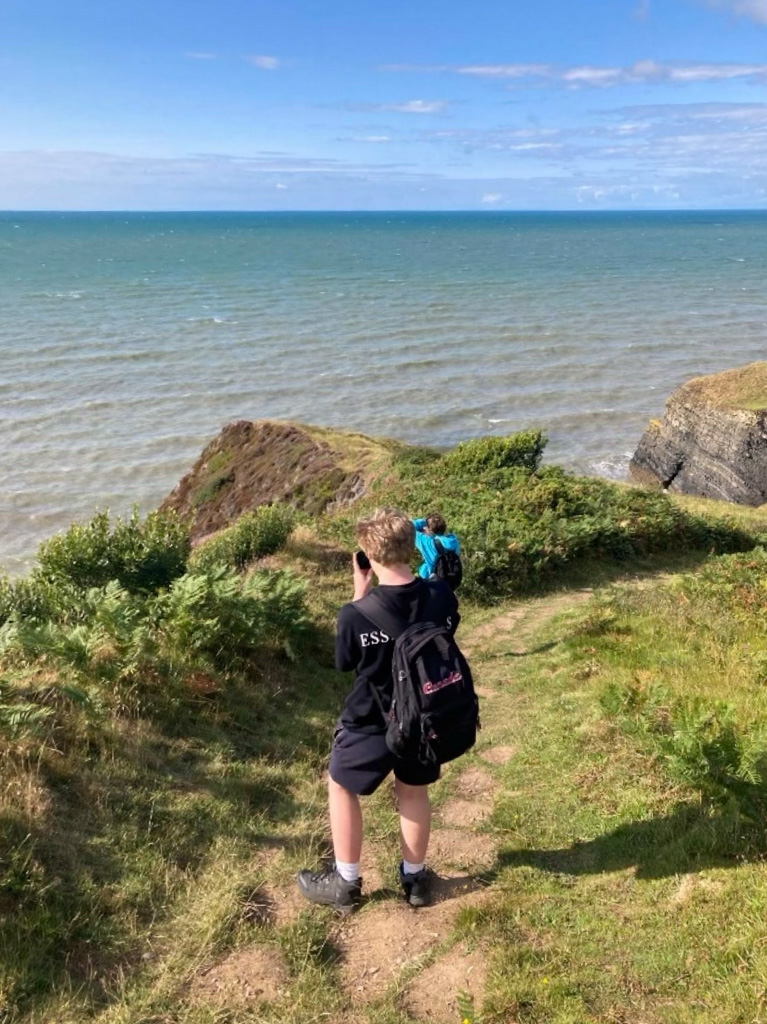 Hikers taking photos along the coast path